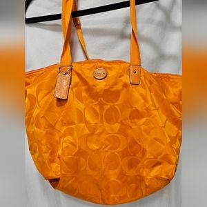 Coach bag with small accessory bag inside. Orange color